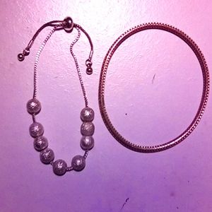 2 bracelets 1 silver tone, one gold tone